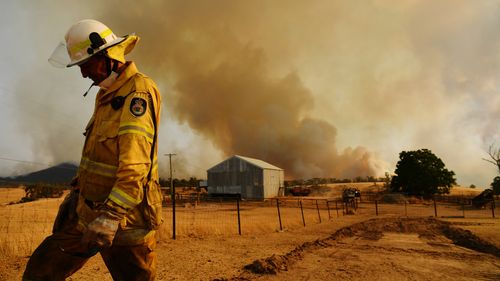 Rural Fire Service firefighter Trevor Stewart close to a fire in Tumburumba. 