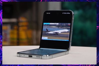 9PR: Image of Samsung Galaxy Z Flip5 flipped halfway while watching videos using Flex Mode
