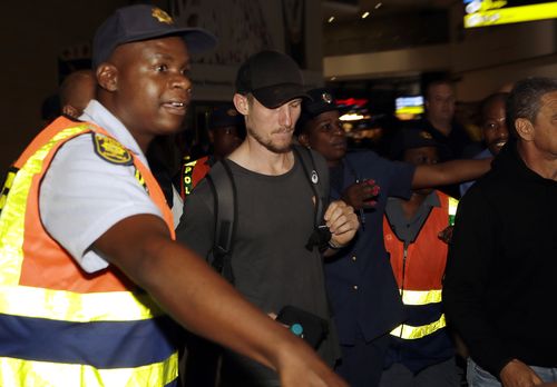 Cameron Bancroft was surrounded by security as he departed the country. (AAP)