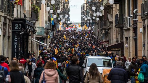 Students take part in a demonstration to protest against the imprisonment of pro-independence leaders and to demand their freedom at Las Ramblas in Barcelona. (AAP)