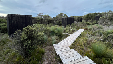 The architecturally designed standing camp of krakani lumi is set within coastal heathland.