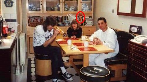 The late Queen frontman Freddie Mercury (right) is pictured in his kitchen with the Russian doll in the background.