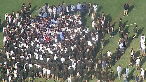 Students gather on the lawn of Trinity Grammar in Melbourne. (9NEWS)