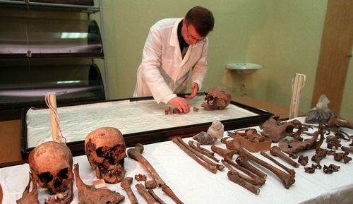 Scientist Alexei Nikitin,  examines bones of Anna Demidova, the Romanov's servant in 1998. The skull of Nicholas II is second from left on the front table next to the skull of his wife, Alexandra. 