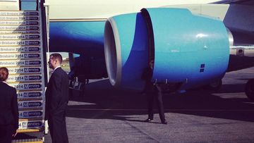A US Secret Service agent craftily uses the engine of Air Force One to conceal himself. (Brisbane Airport)