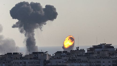 Smoke and flames rise after an Israeli airstrike in Gaza City.