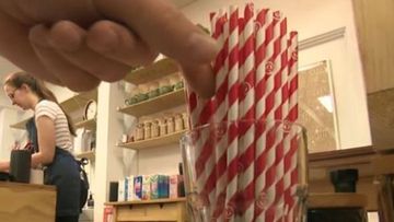 Person picking out a plastic straw.