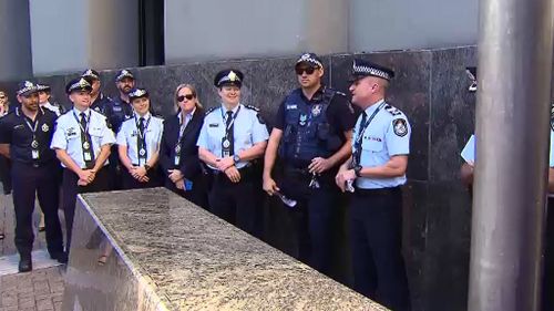 QPS LGBTI Support Network co-ordinator Sergeant Michael Gardiner (far right), with other supporters. (9NEWS)