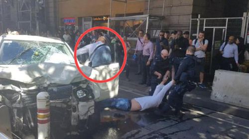 The off-duty police officer, highlighted in red, tackled the driver after he drove through pedestrians. (Supplied)