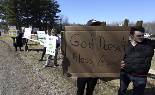 The ceremony attracted protesters hitting back at the Unification Church and its love of guns. (AAP)