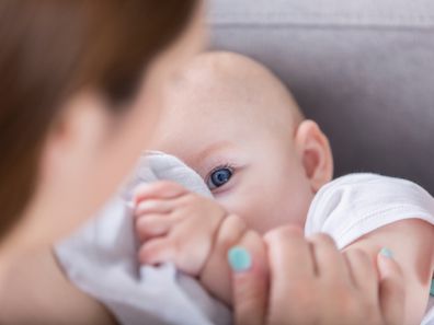 Baby breastfeeding blue eyes