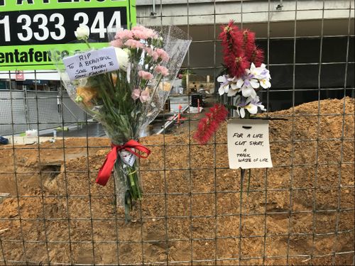 Floral tributes have been placed for a young worker killed at a construction site.