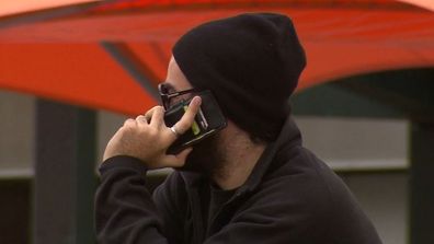 Man on mobile phone scams cyber security telecommunications