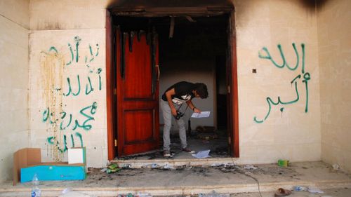 A man looks at documents at the U.S. Consulate in Benghazi, Libya, the day after an attack that killed four Americans, including Ambassador Chris Stevens. (AP)