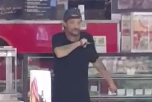 A man was arrested at a Darwin Woolworths after walking into the store armed with two knives.