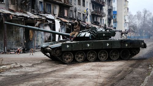  A Ukrainian tank drives down a street in the heavily damaged town of Siversk which is situated near the front lines with Russia.