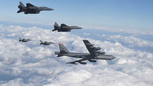 A US B-52 and its fighter escort during a training exercise in South Korea. (AAP)