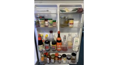 Simon's fridge door is well stocked with sauces.