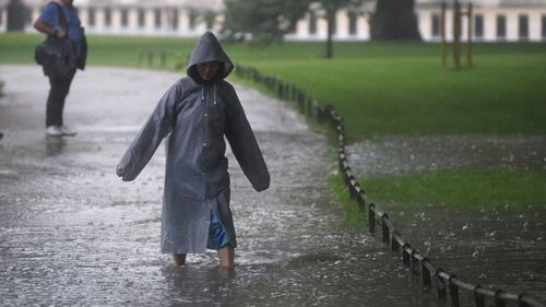 A woman walks through a flooded path in St James's Park in central London.