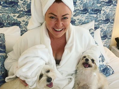 Shelly Horton in bed with her dogs