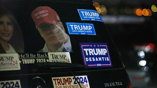 Stickers in support of former President Donald Trump are displayed on the trunk of a sports utility vehicle parked on South Ocean Boulevard near Trump's Mar-a-Lago estate in Palm Beach, Florida, late Monday, August 8, 2022.