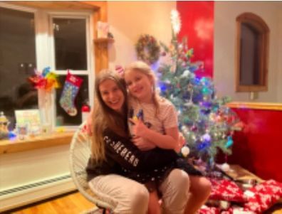 Robyn Lawley with her daughter in front of their Christmas tree.