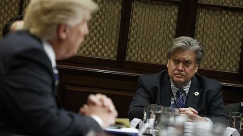 Steve Bannon listens on as Donald Trump speaks. (AP)