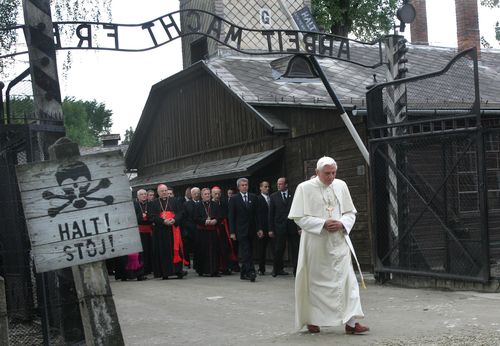Pope Benedict XVI walks through the gate of the former Nazi concentration camp of Auschwitz, with sign above reading in German "Work will set you free", in Oswiecim, Poland, on May 28, 2006. 