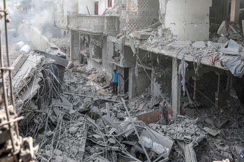 A man stands among the rubble of buildings destroyed in an Israeli bombing in central Gaza.