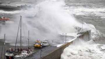 Waves crash over the harbour on October 19, 2023 in Stonehaven, Scotland. 