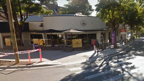 A woman has been stabbed in the neck outside a Sydney cafe.