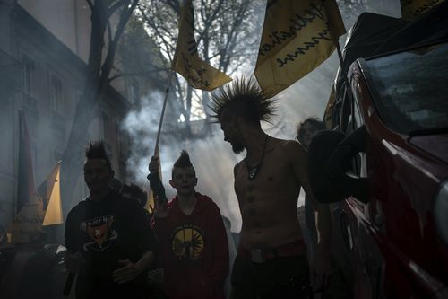 Protesters march during a demonstration in Lyon, central France, Thursday, April 13, 2023. 