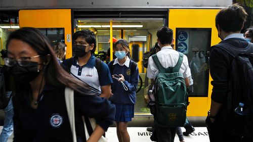 Commuters disembark from a Sydney train.