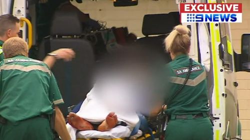 The man was unconscious with stab wounds to his leg when paramedics arrived.
