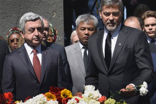 George Clooney and Armenian President Serzh Sarkisian lay flowers at the Genocide Memorial. (AFP)