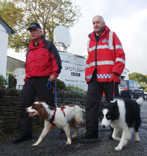 South Yorkshire Police dog handler Martin Grime with dog Eddie (left) in the North Cornwall village of Boscastle conducting a sweep search for possible victims of the 2004 flood which swept through the village.