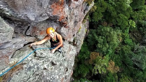 Kiwi climber Anna Parsons hangs on a rock face.