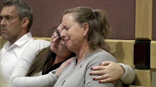 Debbi Hixon, the widow of victim Chris Hixon is consoled in court by close family friend Jennifer Valliere during a hearing for Parkland school shooting suspect Nikolas Cruz. 