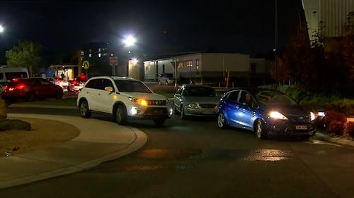 Cars queue outside the Northern Hospital testing site in Melbourne