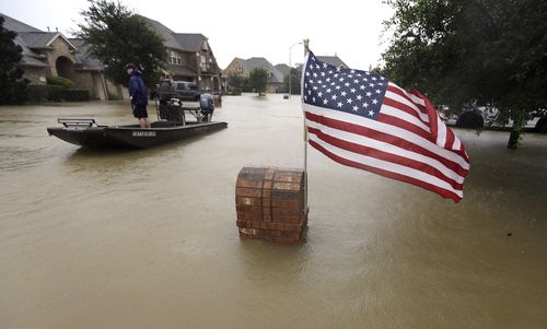 Volunteers use their boat to help evacuate residents. (AP)