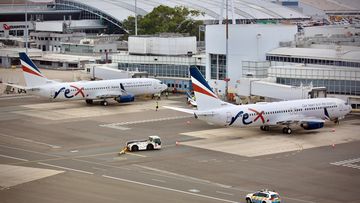 Rex aircraft at an airport.