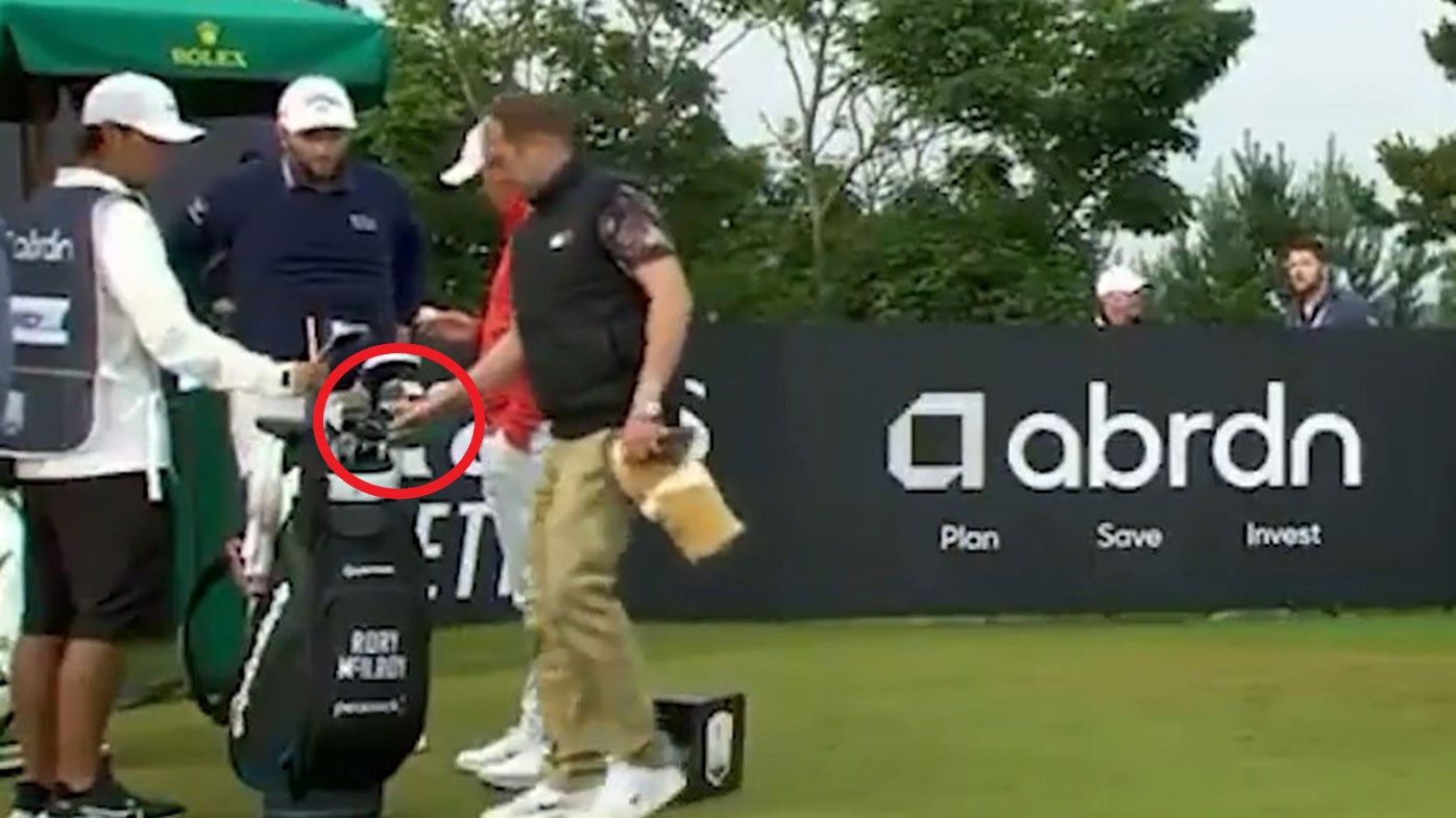 A spectator takes one of Rory McIlroy&#x27;s clubs at the Scottish Open.