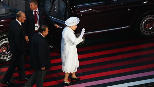 Queen Elizabeth II, Patron of the CGF waves as she walks with Prince Imran the CGF President during the Opening Ceremony for the Glasgow 2014 Commonwealth Games. (Getty)