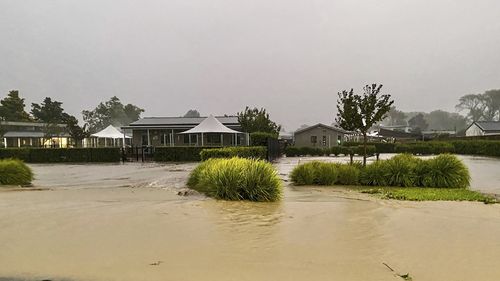 Water floods a street in Havelock North, southeast of Auckland, New Zealand, Tuesday, Feb. 14, 2023. 