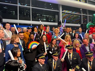 Crew and passengers celebrate before boarding the Pride Flight from San Francisco to Sydney.