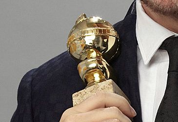 Which host repeatedly joked Golden Globes voters accepted bribes?
