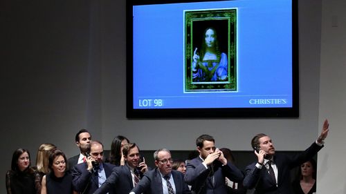 Bidding representatives react after Leonardo da Vinci's "Salvator Mundi" sold for $591m at Christie's