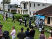 Crowds peer at a house auction in Sydney