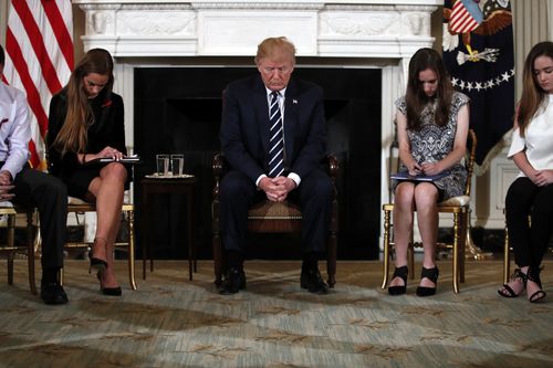 Mr Trump was surrounded by students who survived the shooting in Parkland, Florida. (AAP)