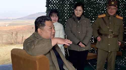North Korean leader Kim Jong Un, wife Ri Sol Ju and their daughter with military officials